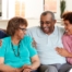 A couple sits with aging parents and enjoys their time together.