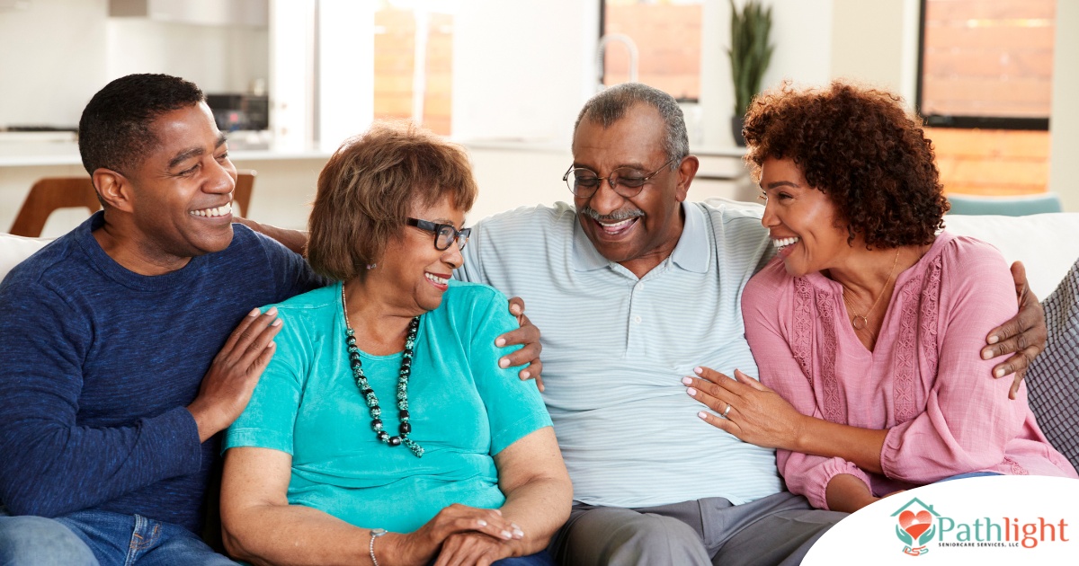 A couple sits with aging parents and enjoys their time together.