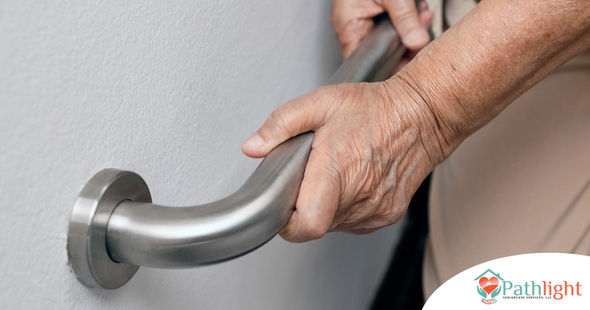 An older adult uses a grab bar representing one of the home modifications that is helpful for fall prevention for elderly adults.